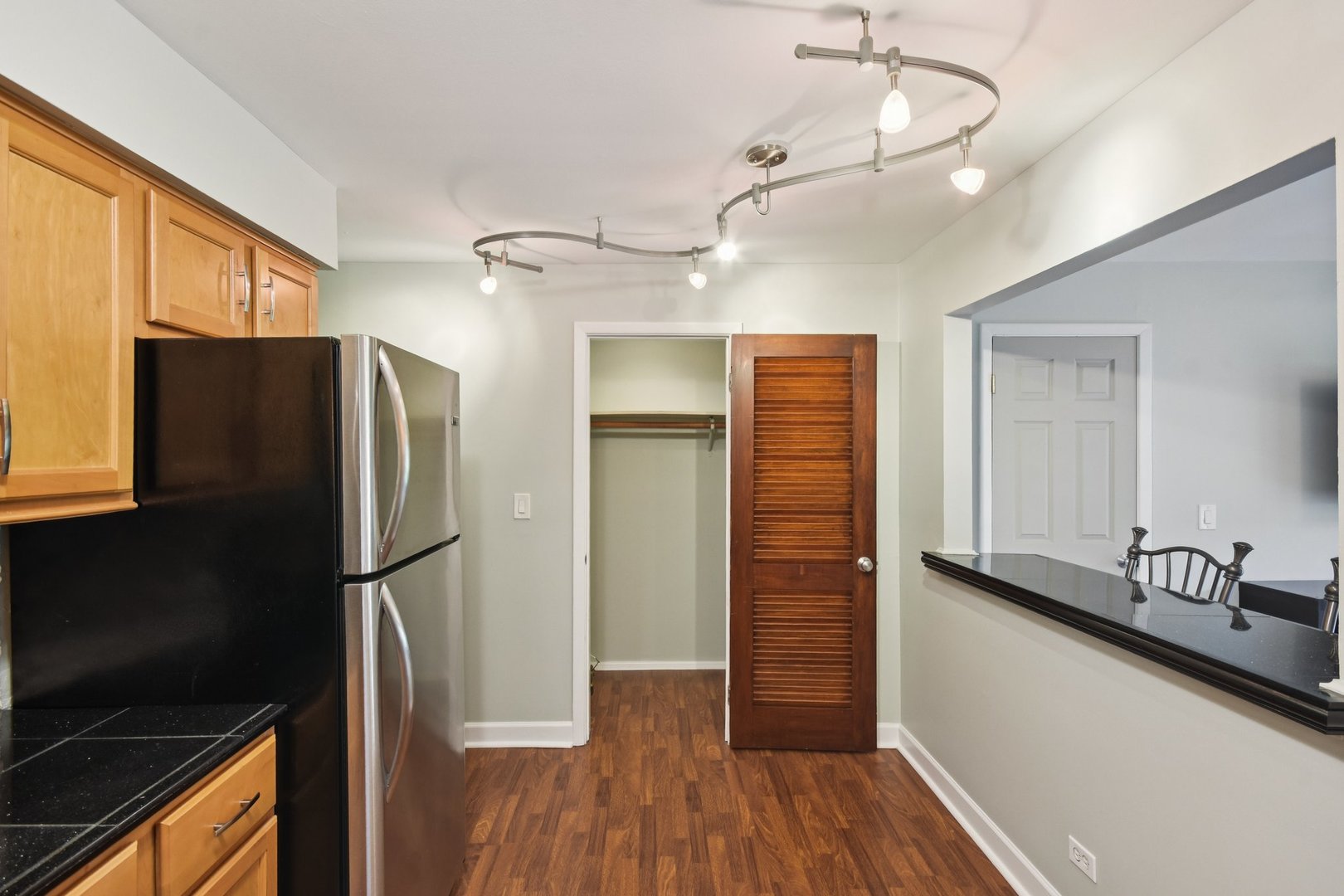 493 McHenry Road, Unit 1B Wheeling, IL 60090 - Photo 11 of 30 a kitchen with stainless steel appliances granite countertop a refrigerator and a sink