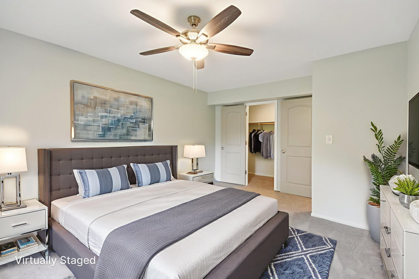 493 McHenry Road, Unit 1B Wheeling, IL 60090 - Photo 14 of 30 a bedroom with a large bed and a chandelier