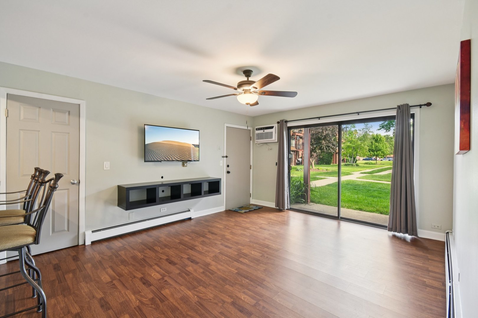 493 McHenry Road, Unit 1B Wheeling, IL 60090 - Photo 2 of 30 a living room with furniture and a flat screen tv