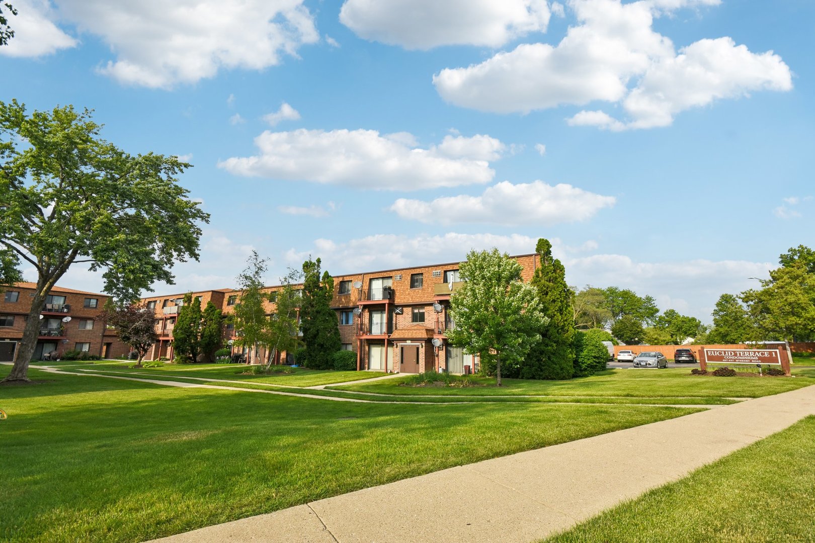 493 McHenry Road, Unit 1B Wheeling, IL 60090 - Photo 28 of 30 a view of a park with multi story residential apartment building in front of it
