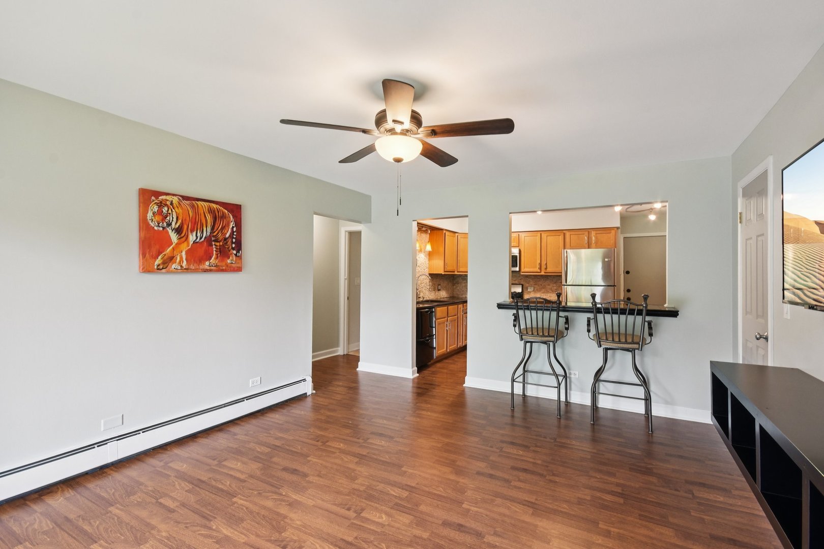 493 McHenry Road, Unit 1B Wheeling, IL 60090 - Photo 5 of 30 a view of a livingroom with furniture wooden floor and a ceiling fan