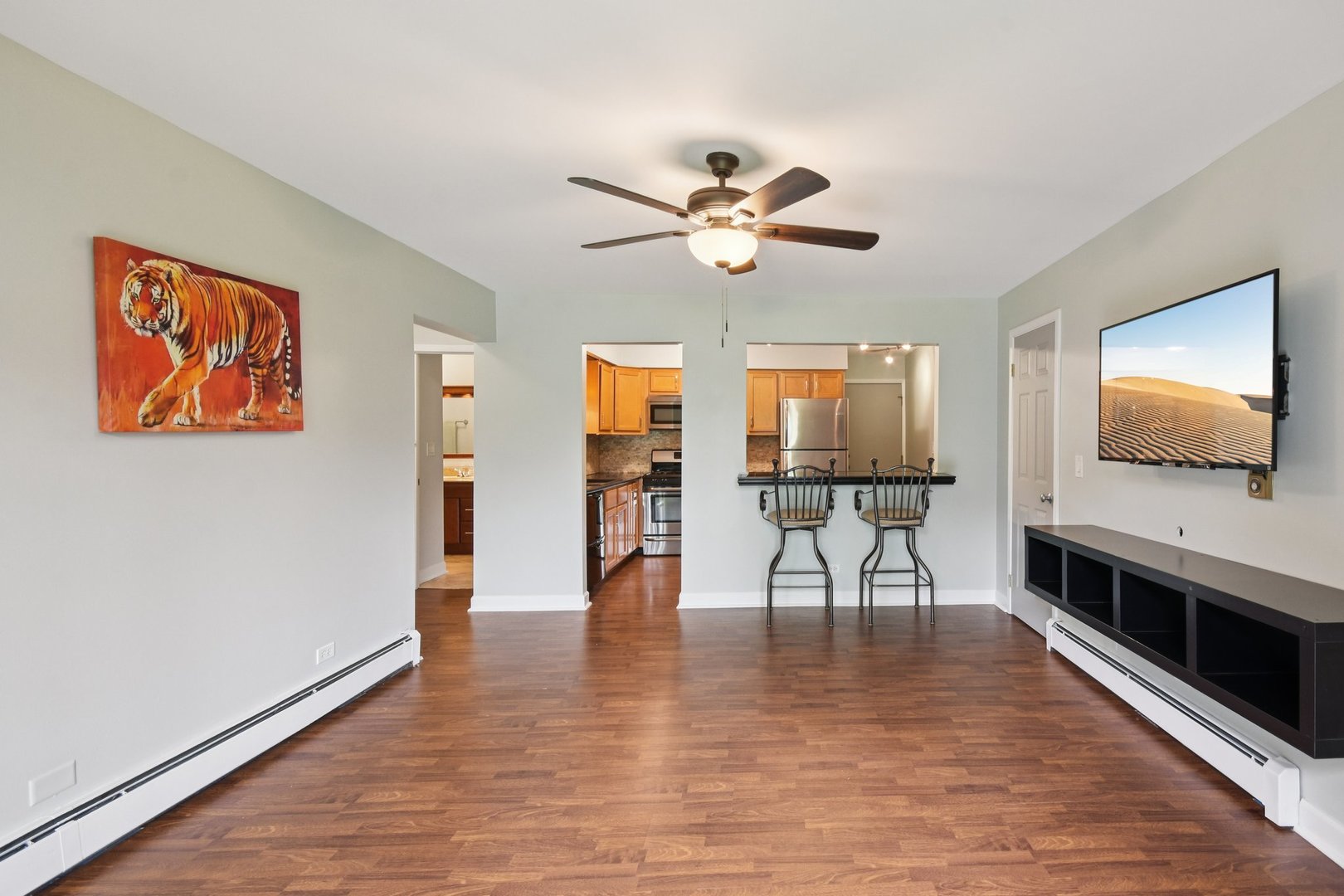 493 McHenry Road, Unit 1B Wheeling, IL 60090 - Photo 6 of 30 a view of a livingroom with furniture and a flat screen tv