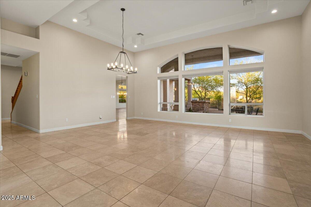 8540 East McDowell Road, Unit 119 Mesa, AZ 85207 - Photo 17 of 94 a view of a livingroom with a chandelier curtains and large windows