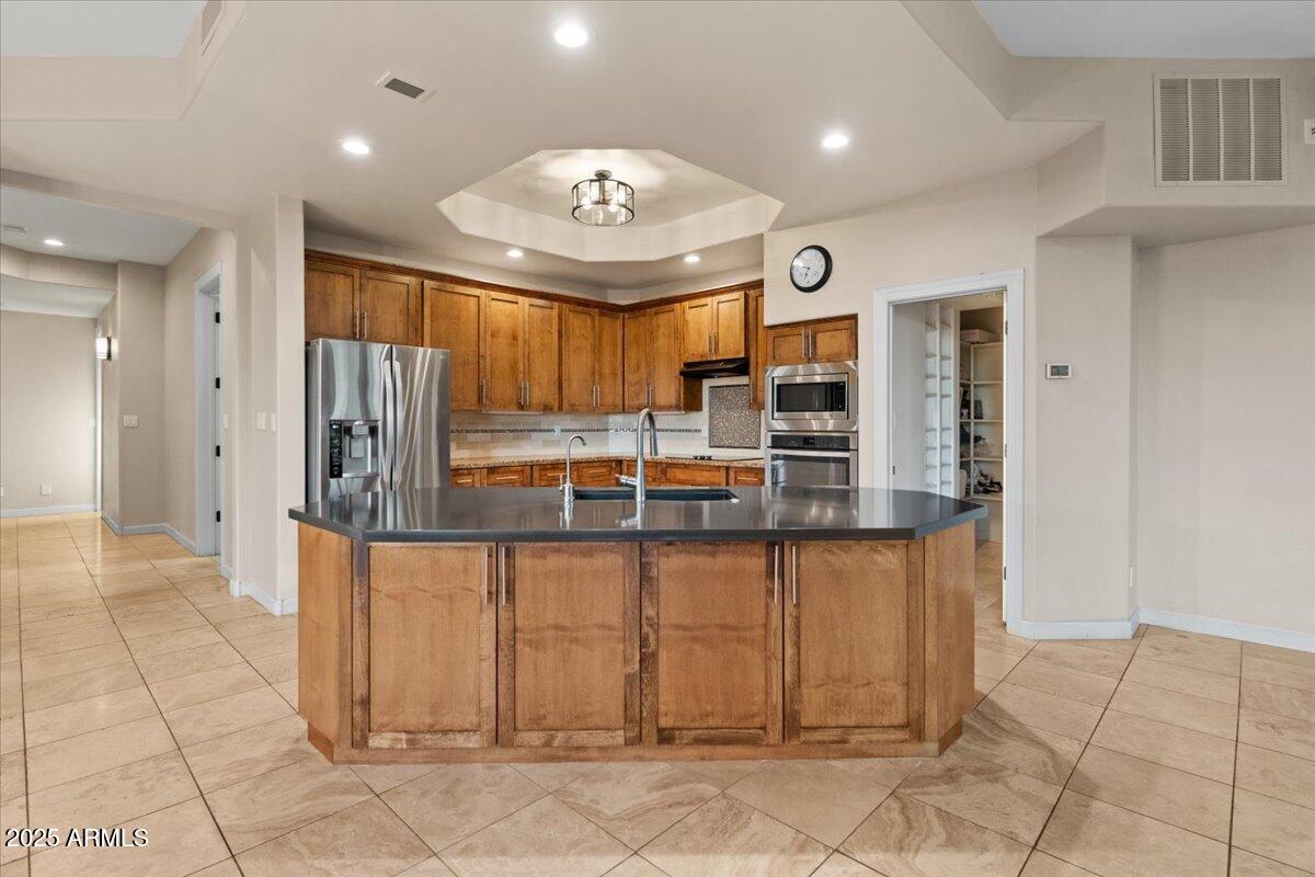8540 East McDowell Road, Unit 119 Mesa, AZ 85207 - Photo 21 of 94 a view of a kitchen with granite countertop cabinets and stainless steel appliances
