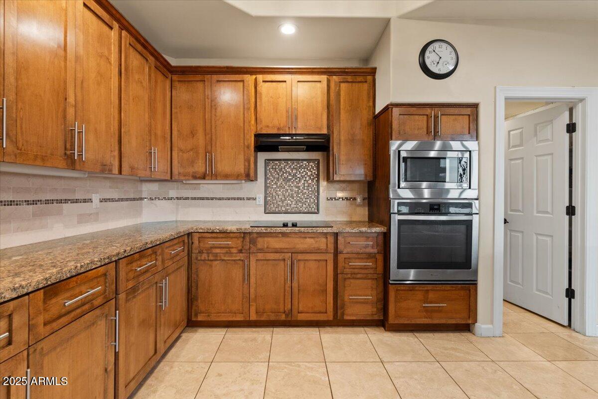 8540 East McDowell Road, Unit 119 Mesa, AZ 85207 - Photo 22 of 94 a kitchen with stainless steel appliances granite countertop a refrigerator and a sink