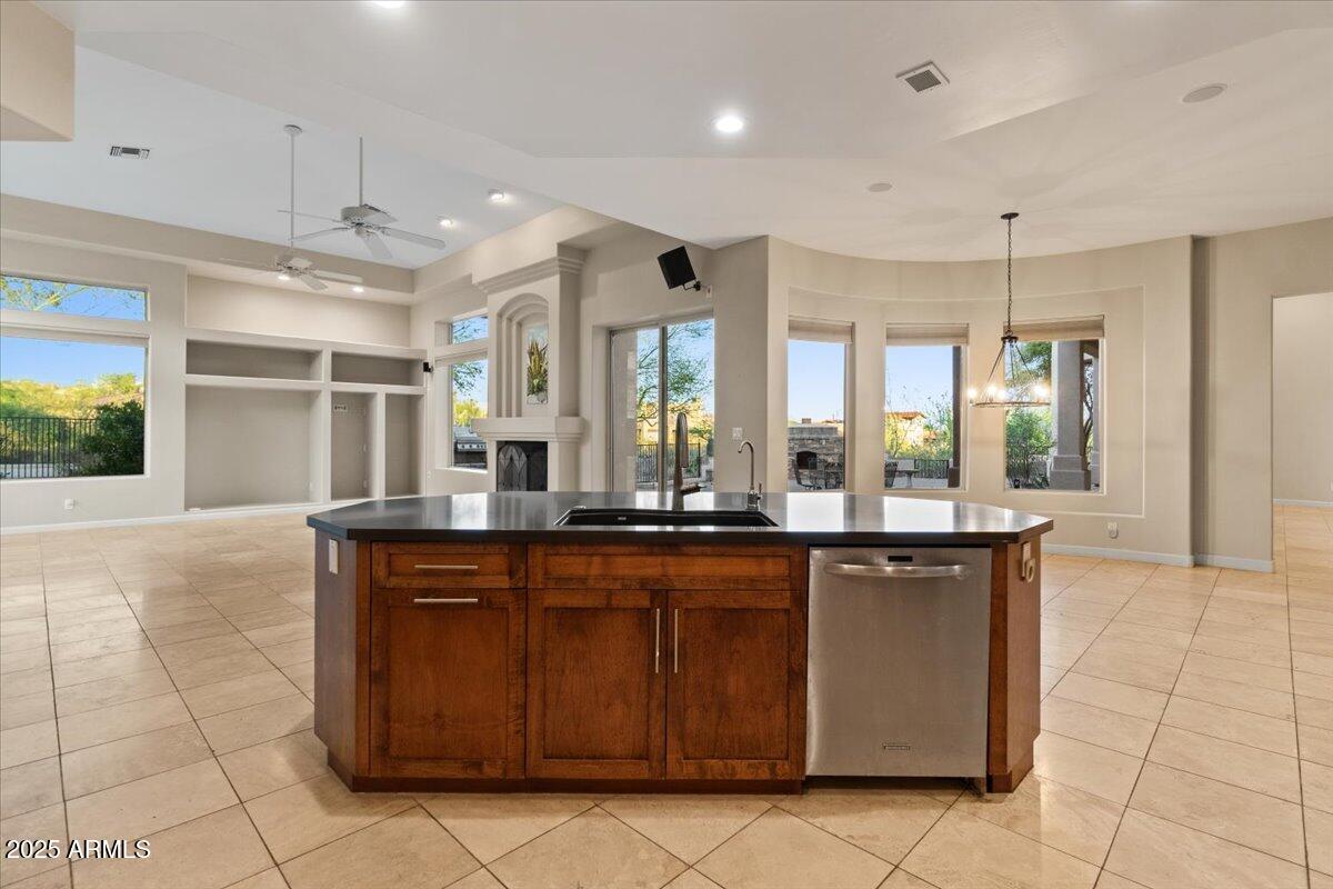 8540 East McDowell Road, Unit 119 Mesa, AZ 85207 - Photo 23 of 94 a large kitchen with kitchen island granite countertop a stove a sink and a refrigerator