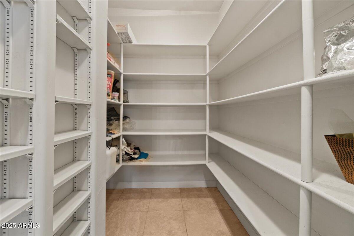 8540 East McDowell Road, Unit 119 Mesa, AZ 85207 - Photo 32 of 94 a view of walk in closet with empty racks