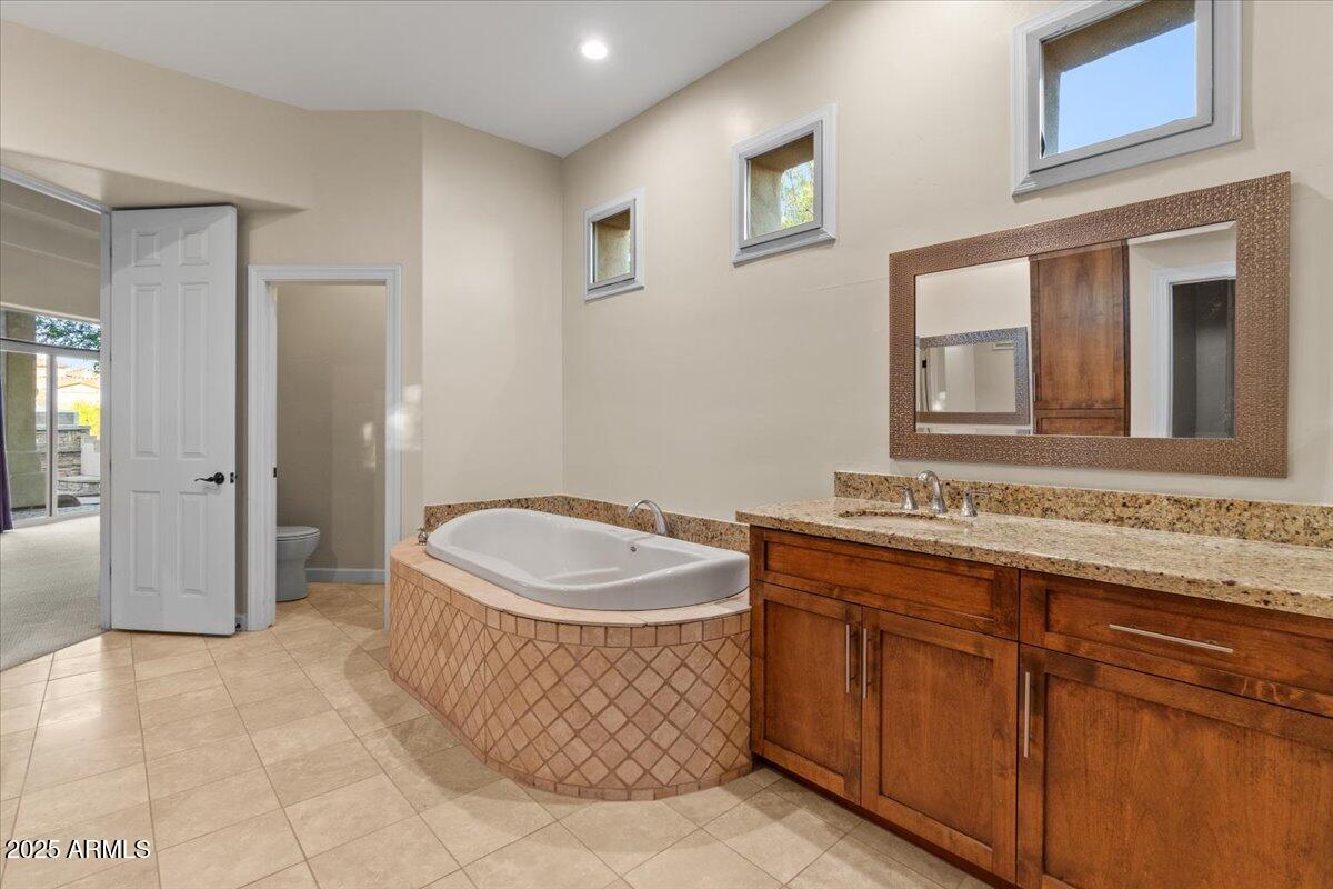 8540 East McDowell Road, Unit 119 Mesa, AZ 85207 - Photo 37 of 94 a spacious bathroom with a sink and a mirror