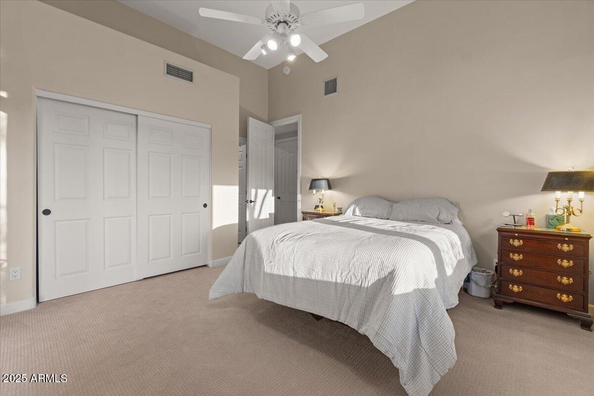 8540 East McDowell Road, Unit 119 Mesa, AZ 85207 - Photo 46 of 94 a spacious bedroom with a bed and a chandelier