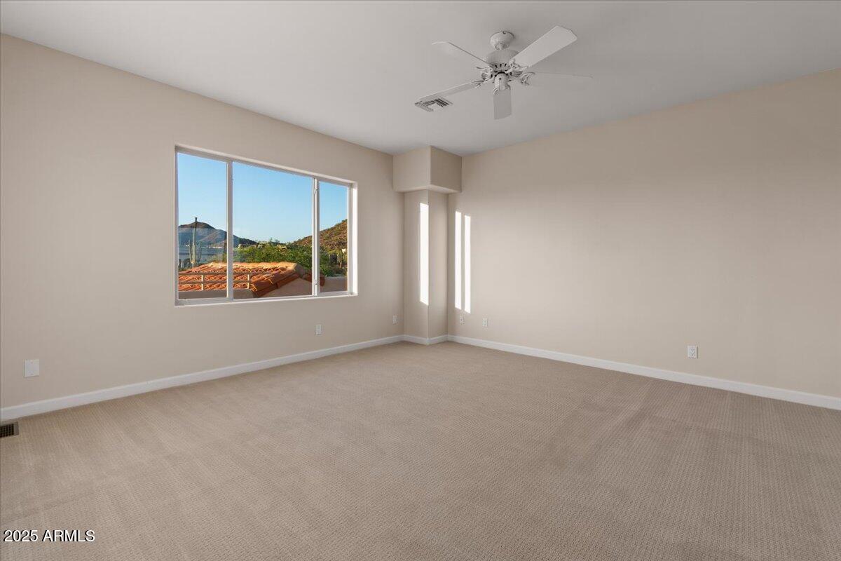 8540 East McDowell Road, Unit 119 Mesa, AZ 85207 - Photo 50 of 94 an empty room with windows and ceiling fan