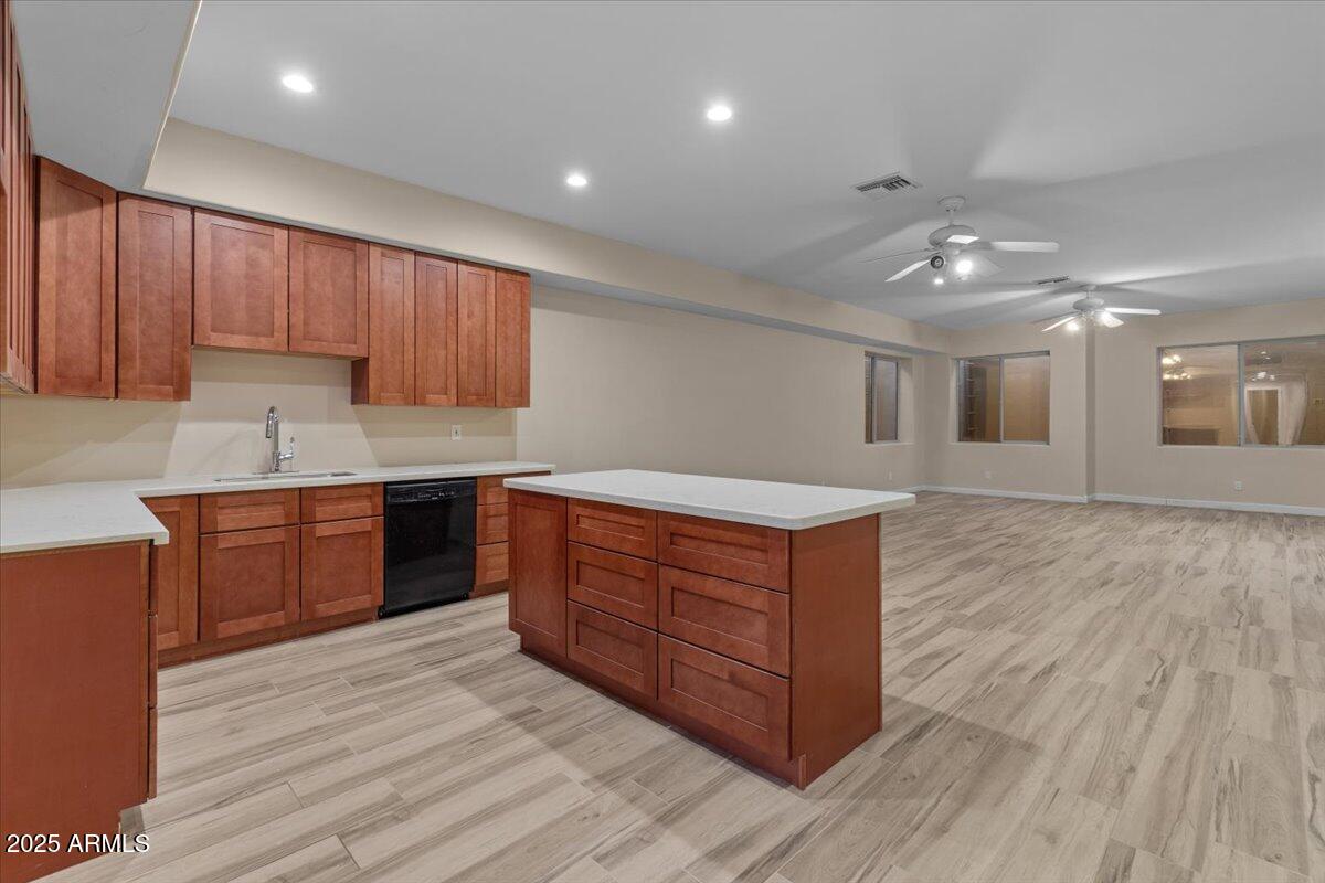 8540 East McDowell Road, Unit 119 Mesa, AZ 85207 - Photo 54 of 94 a kitchen with wooden floors and wooden cabinets