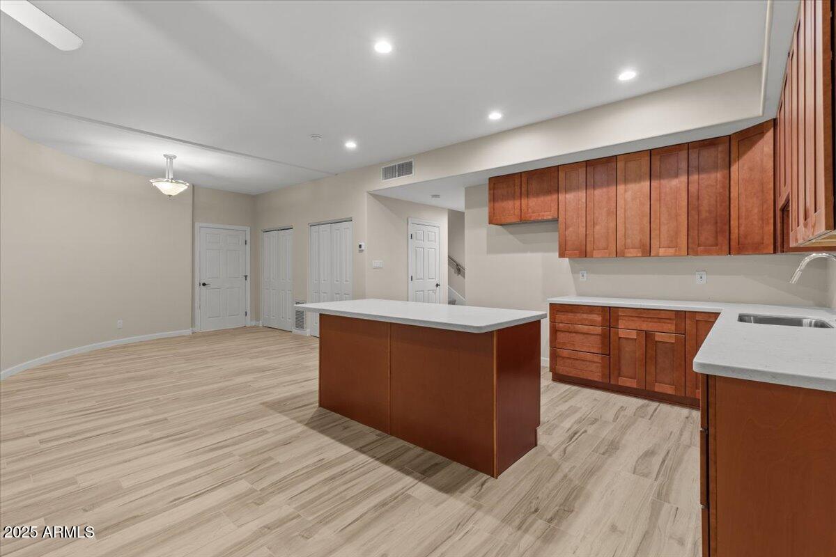 8540 East McDowell Road, Unit 119 Mesa, AZ 85207 - Photo 55 of 94 a kitchen with stainless steel appliances granite countertop a sink wooden cabinets and a granite counter tops