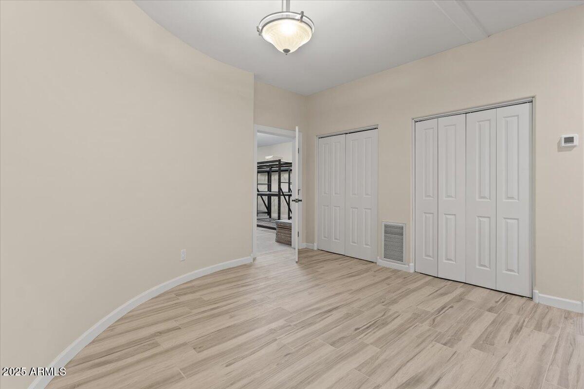 8540 East McDowell Road, Unit 119 Mesa, AZ 85207 - Photo 58 of 94 wooden floor in an empty room