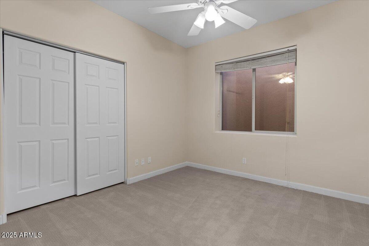 8540 East McDowell Road, Unit 119 Mesa, AZ 85207 - Photo 60 of 94 an empty room with a chandelier fan