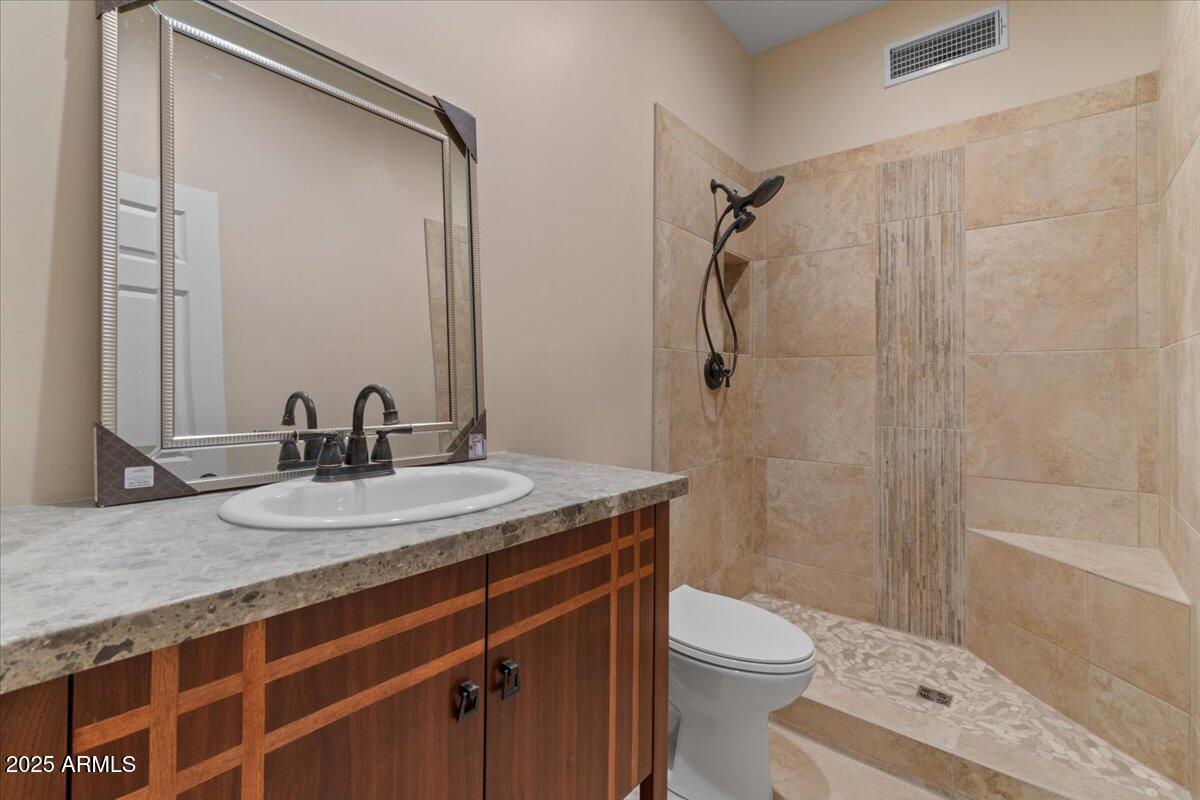 8540 East McDowell Road, Unit 119 Mesa, AZ 85207 - Photo 66 of 94 a bathroom with a granite countertop sink toilet and shower