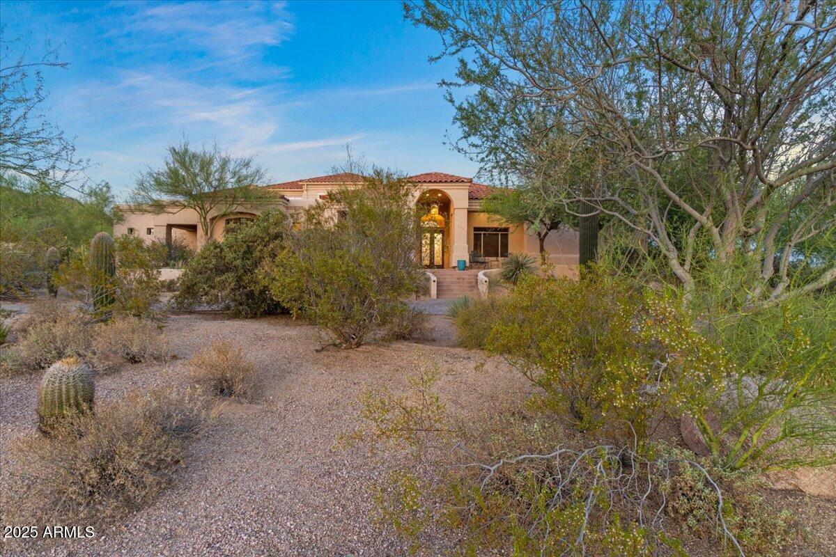 8540 East McDowell Road, Unit 119 Mesa, AZ 85207 - Photo 6 of 94 a front view of a house with plants and trees