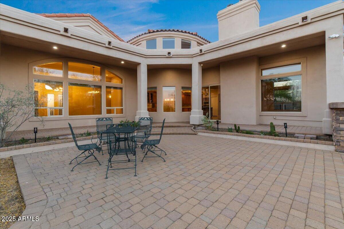 8540 East McDowell Road, Unit 119 Mesa, AZ 85207 - Photo 73 of 94 a view of a patio with table and chairs and potted plants