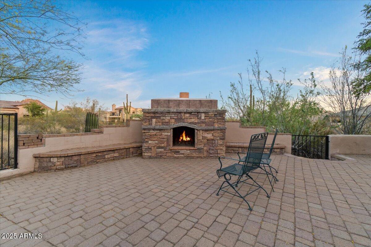 8540 East McDowell Road, Unit 119 Mesa, AZ 85207 - Photo 74 of 94 a view of a terrace with furniture and a fireplace