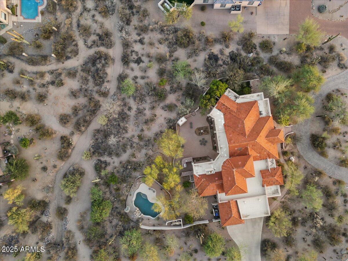 8540 East McDowell Road, Unit 119 Mesa, AZ 85207 - Photo 89 of 94 an aerial view of a house with a yard and large trees