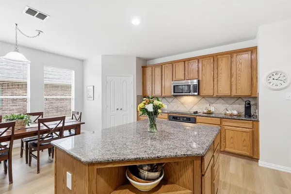 a kitchen with stainless steel appliances granite countertop refrigerator sink and stove