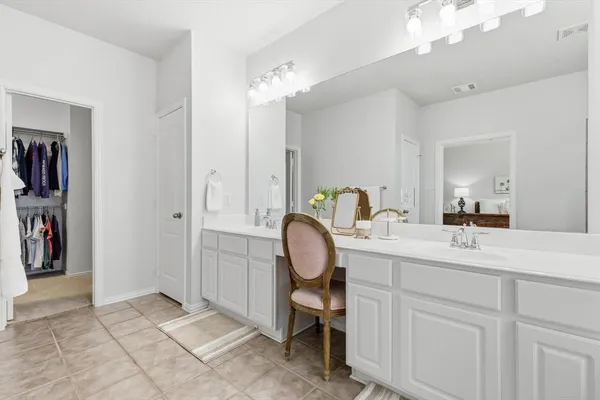 a bathroom with a sink double vanity mirror and a bathtub