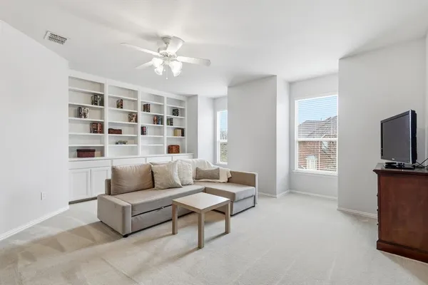 a living room with furniture and kitchen view