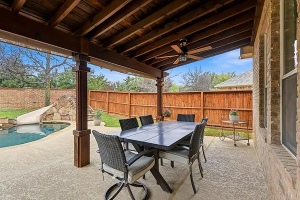 a view of a patio with table and chairs and potted plants