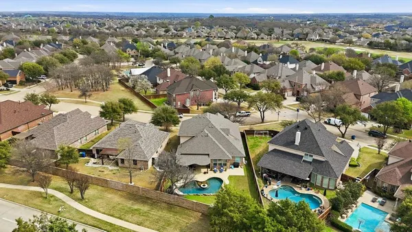 an aerial view of a house with garden space and sitting area