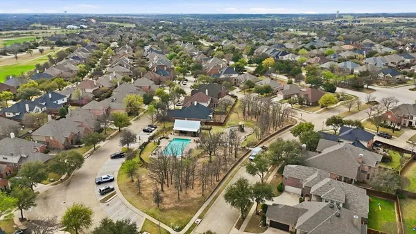 an aerial view of residential houses with outdoor space