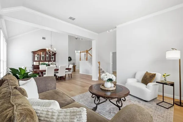 a living room with furniture and wooden floor