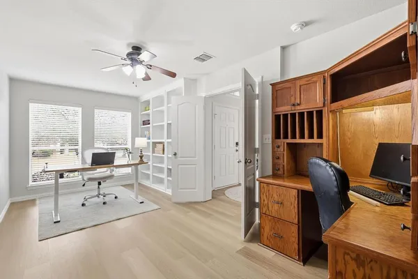 a living room with furniture windows and wooden floor