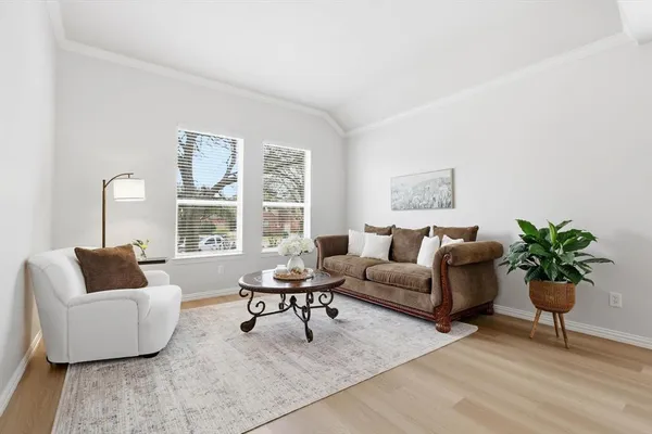 a living room with furniture and a potted plant on table