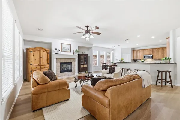 a living room with furniture kitchen view and a fireplace