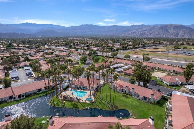 a view of a house with swimming pool and sitting area