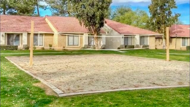 a front view of multiple houses with yard