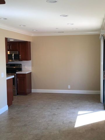 a view of kitchen with microwave and cabinets