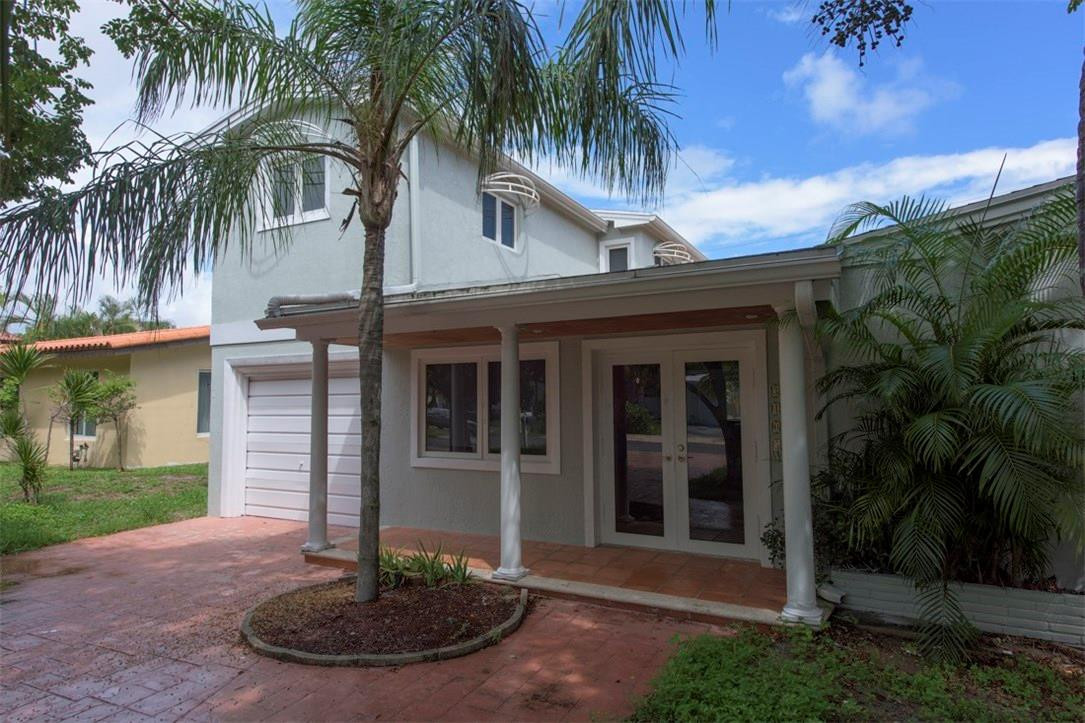 3405 Leigh Road Pompano Beach, FL 33062 - Photo 1 of 35 a front view of a house with a yard