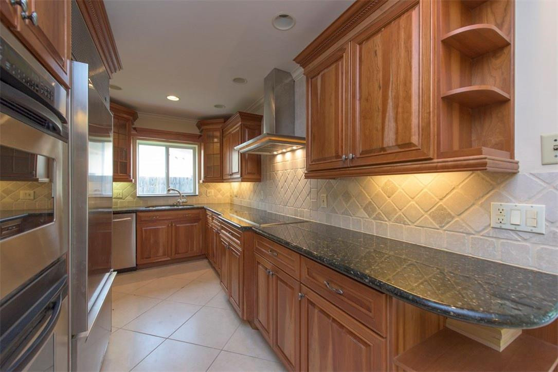 3405 Leigh Road Pompano Beach, FL 33062 - Photo 15 of 35 a kitchen with stainless steel appliances granite countertop a sink and a stove