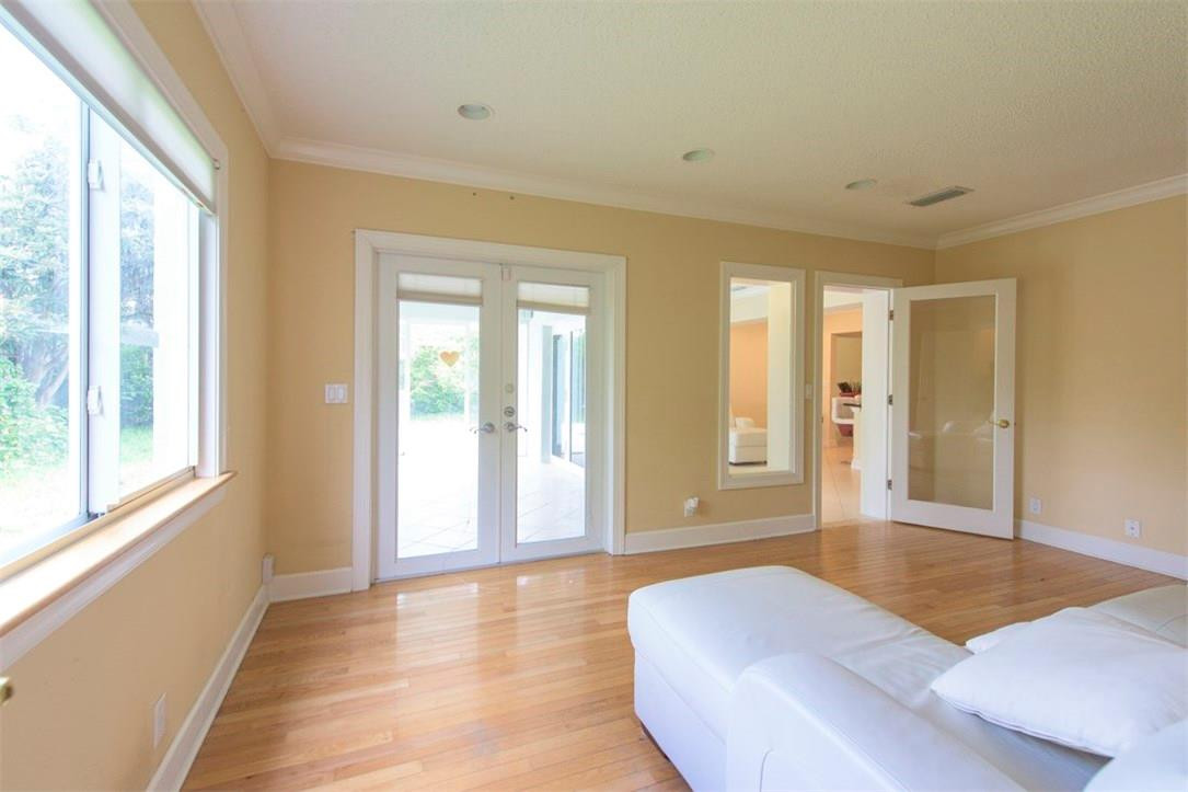 3405 Leigh Road Pompano Beach, FL 33062 - Photo 17 of 35 a spacious bedroom with a large bed and wooden floor