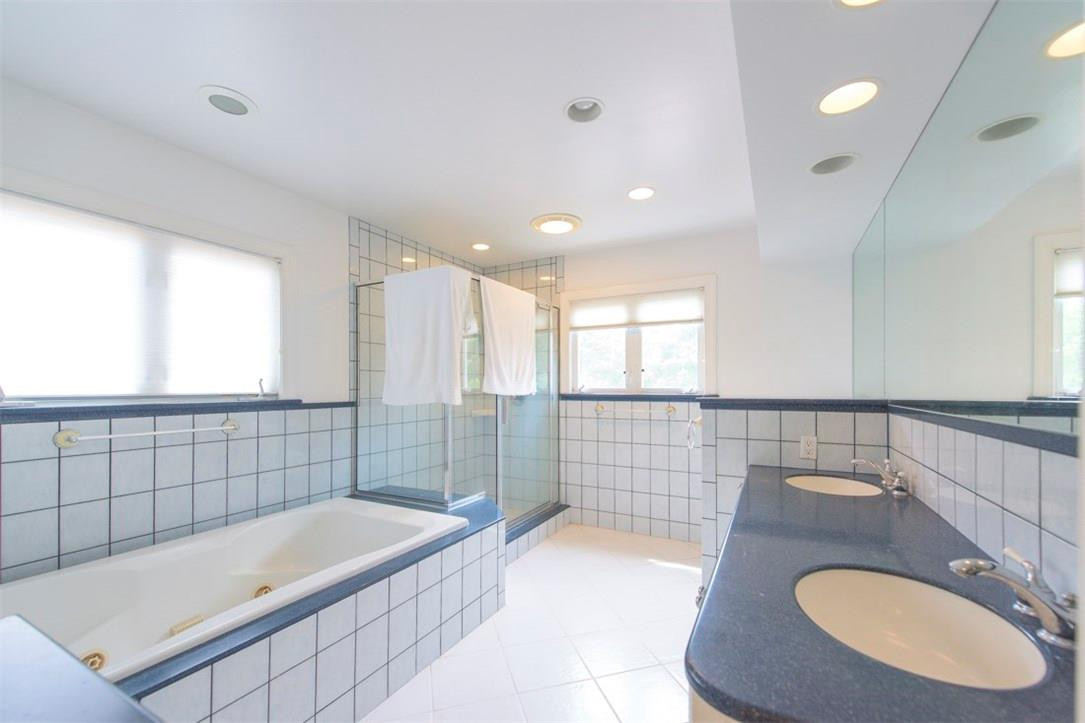 3405 Leigh Road Pompano Beach, FL 33062 - Photo 20 of 35 a bathroom with a granite countertop sink a bathtub and window