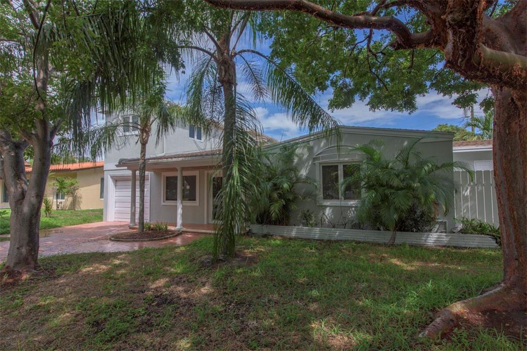 3405 Leigh Road Pompano Beach, FL 33062 - Photo 26 of 35 front view of a house with a yard