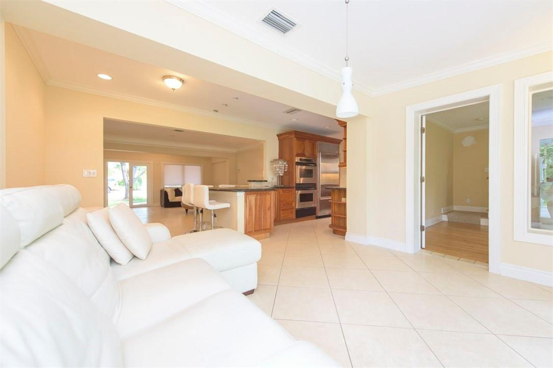 3405 Leigh Road Pompano Beach, FL 33062 - Photo 7 of 35 a view of a livingroom with furniture and kitchen view