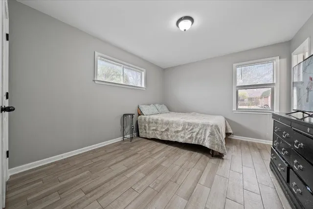 a bathroom with a granite countertop toilet sink and mirror