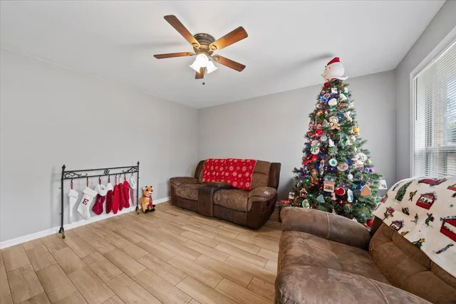 a living room with furniture and a christmas tree