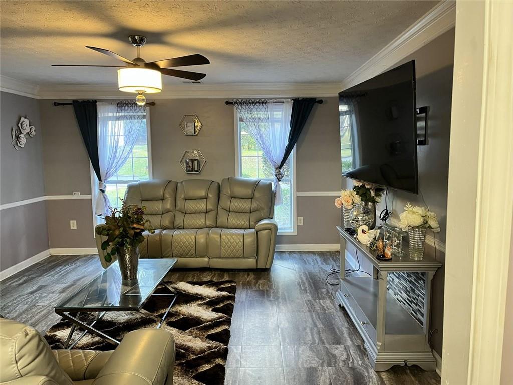 800 Sinclair Way Jonesboro, GA 30238 - Photo 5 of 10 a living room with furniture and a flat screen tv