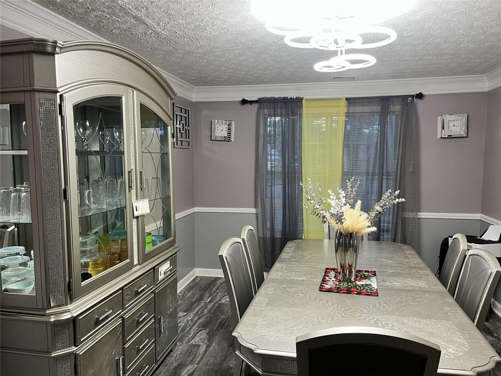 800 Sinclair Way Jonesboro, GA 30238 - Photo 6 of 10 a view of a dining room with furniture wooden floor and chandelier