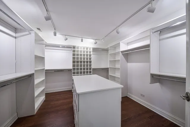 a view of storage and utility room with wooden floor