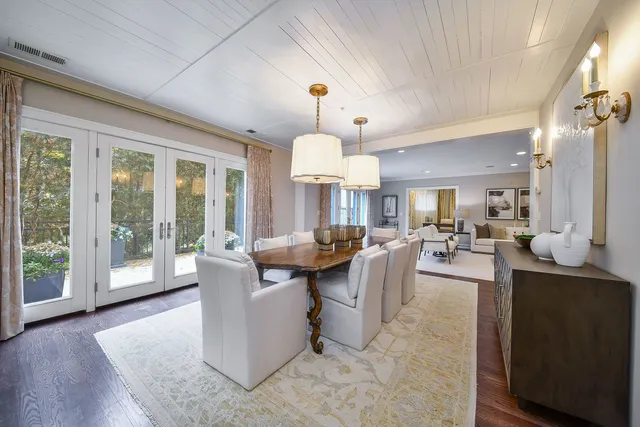 a living room with fireplace furniture and a chandelier