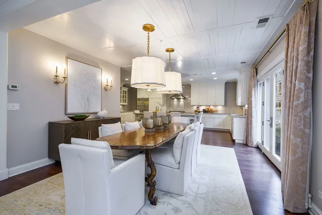 a view of a dining room with furniture and a chandelier