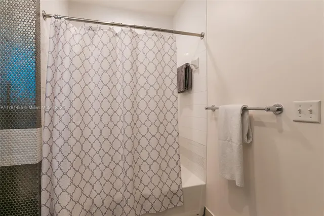 a bathroom with a shower curtain